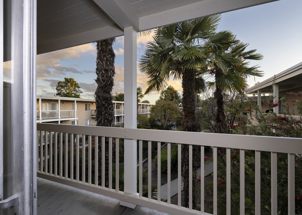 view of palm trees from the porch of a condo