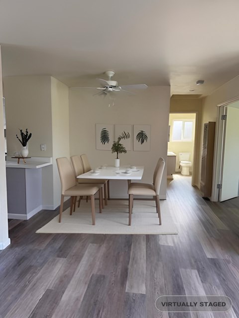 A dining room with a table and chairs.