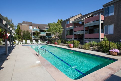 a swimming pool in front of an apartment building