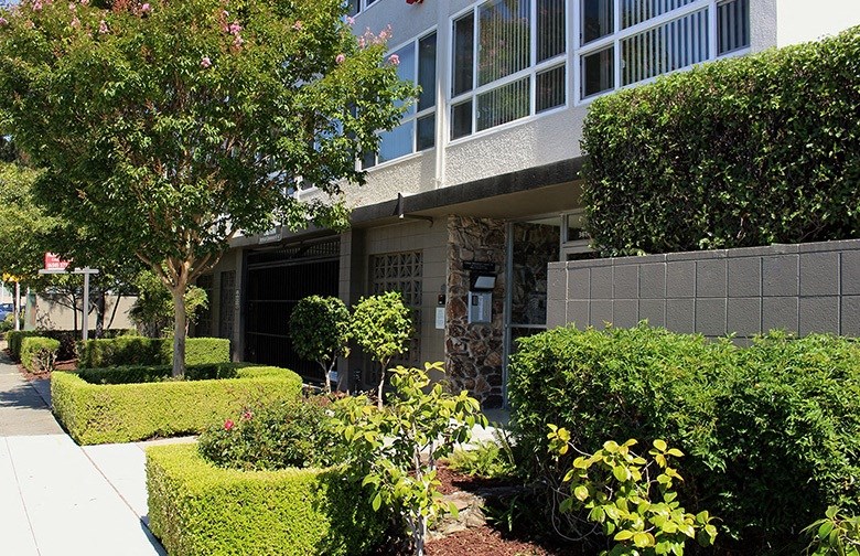 Front of 36th ave Apartments a building with large windows facing the street side