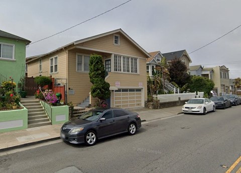 a house with cars parked on the street
