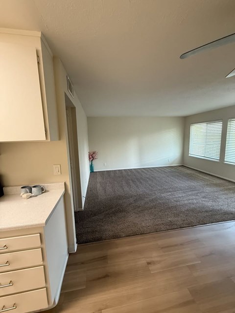 A kitchen with white cabinets and a countertop with a few items on it.