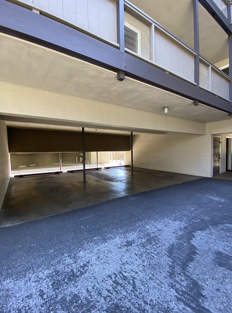 the inside of a parking garage with a gravel floor
