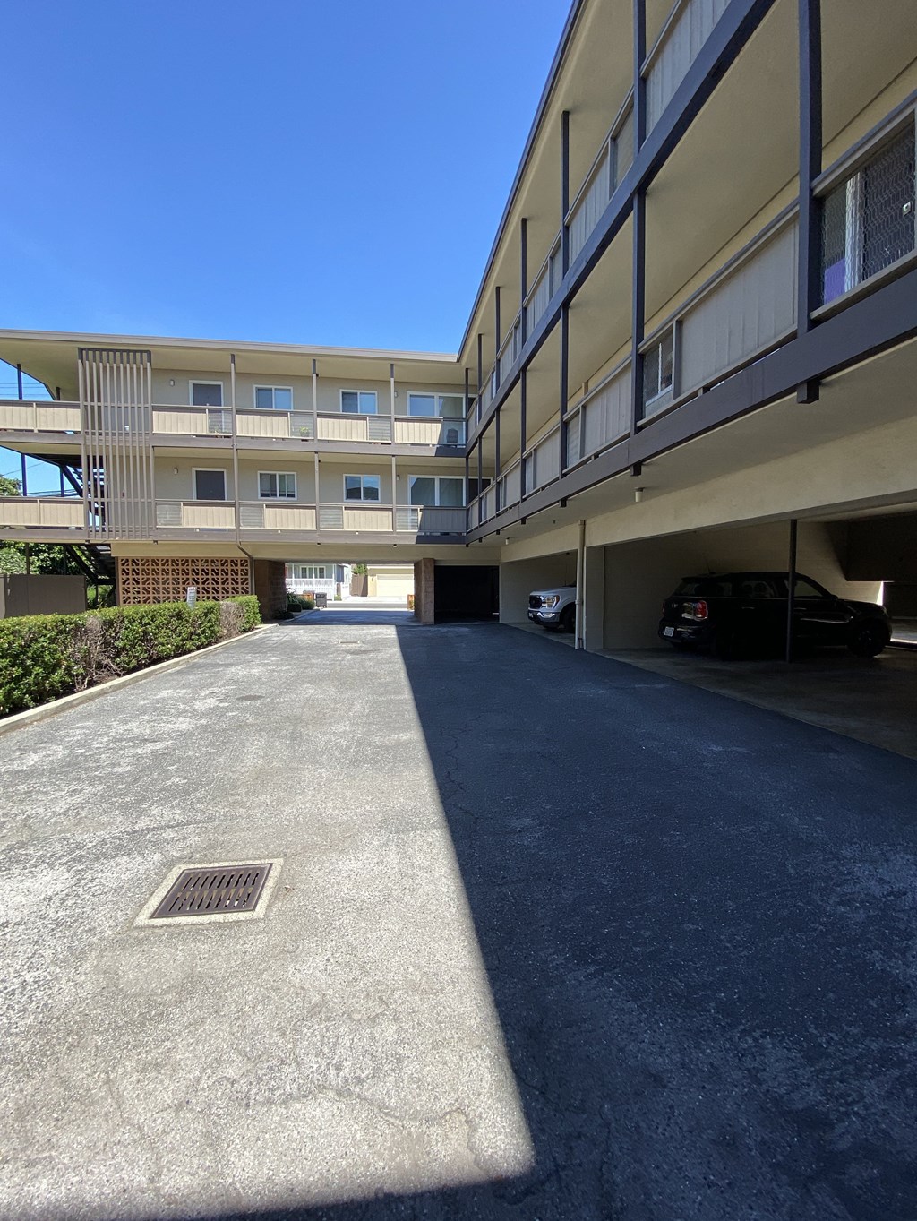 an empty parking lot in front of an apartment building