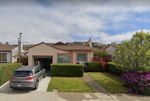 a house with a car parked in front of it