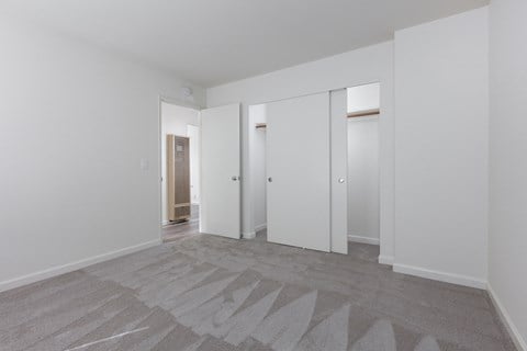 a living room with white walls and white doors
