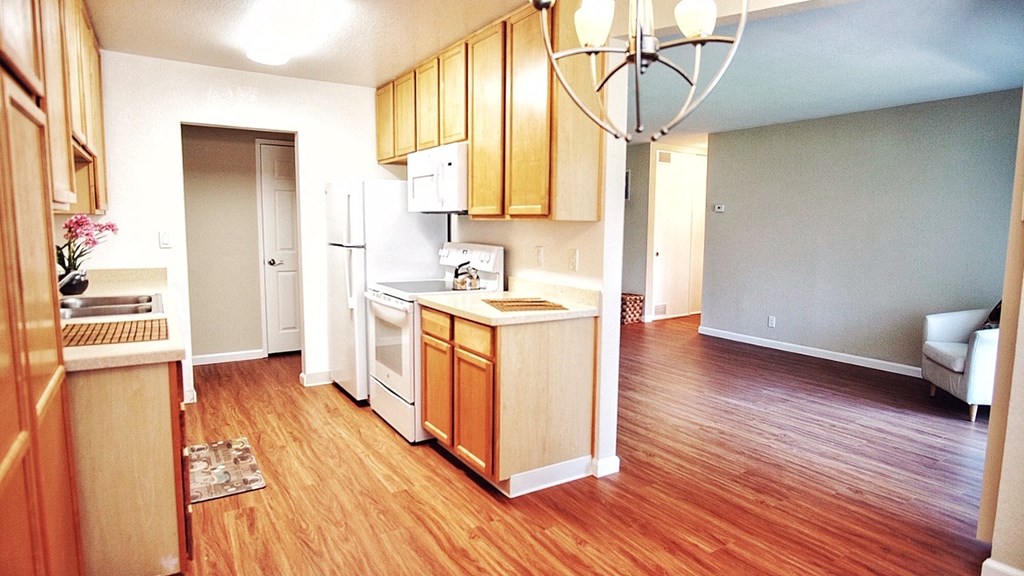a kitchen and living room with a hard wood floor
