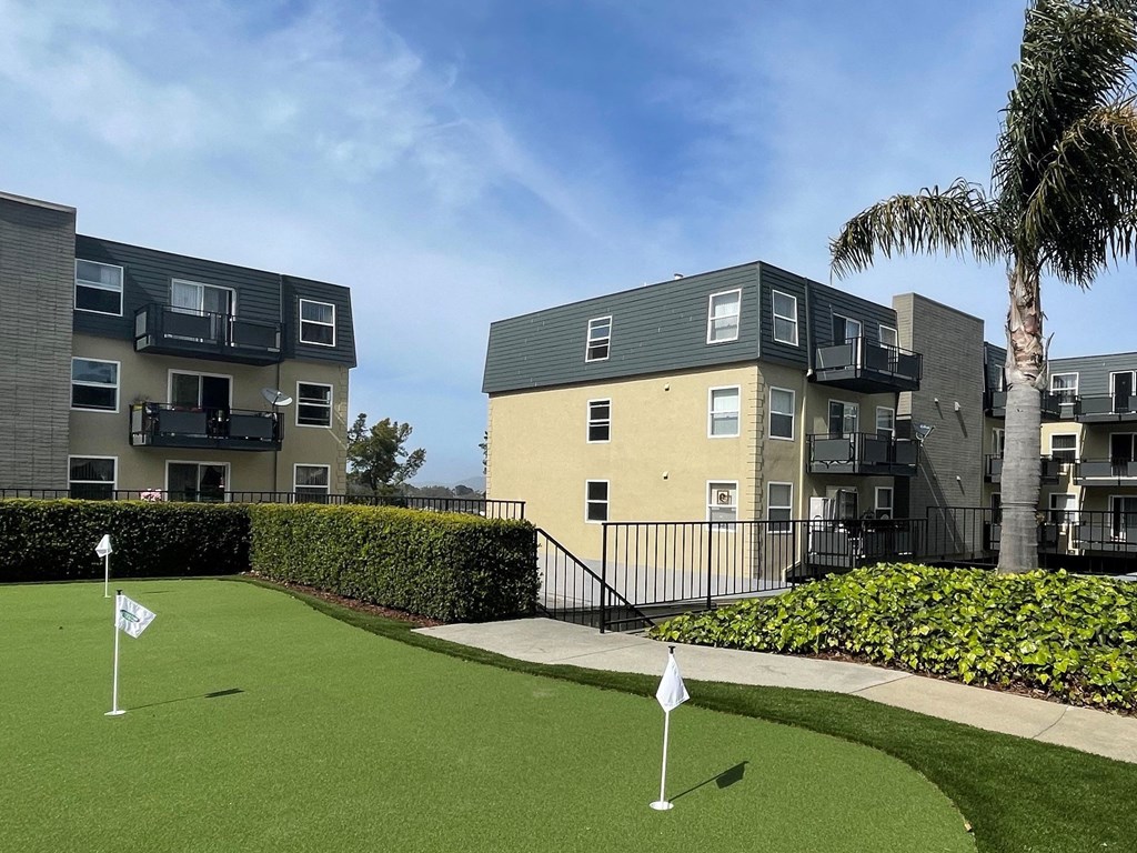 a golf course in front of an apartment building