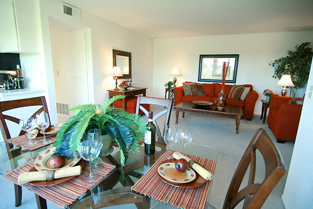 The view from the dining room into the living room with red couches and a green plant Prodesse Property Group 1211 Garbo Way  San Jose, CA 95117
