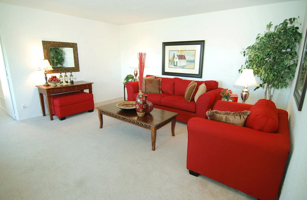 Red couches in the living room of a unit at Prodesse Property Group 1211 Garbo Way  San Jose, CA 95117