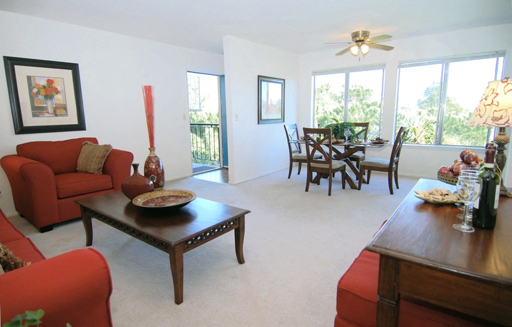 Red couches in the living room facing the dining room set of a unit at Prodesse Property Group 1211 Garbo Way  San Jose, CA 95117
