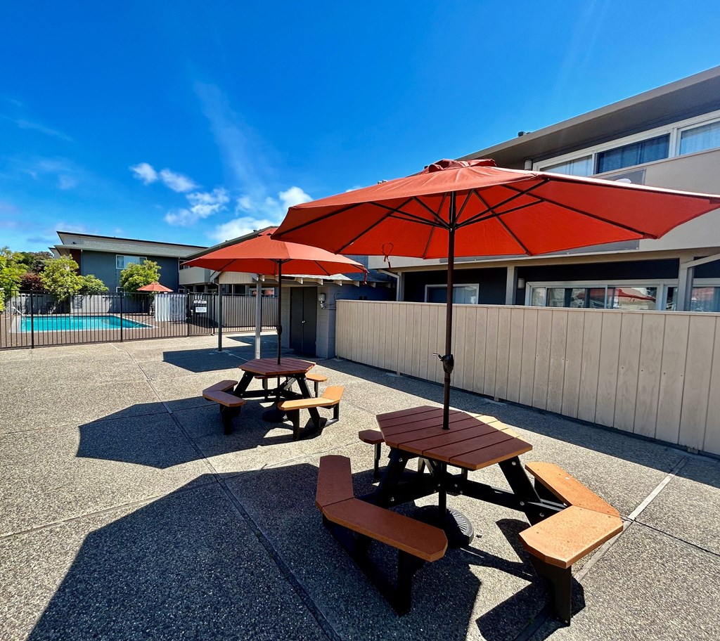 South Delaware Apts Pool tables with large umbrellas