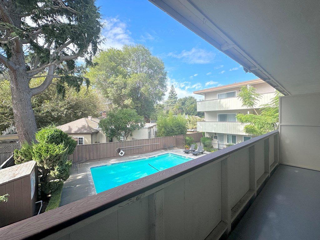 a view of the pool from the balcony of an apartment