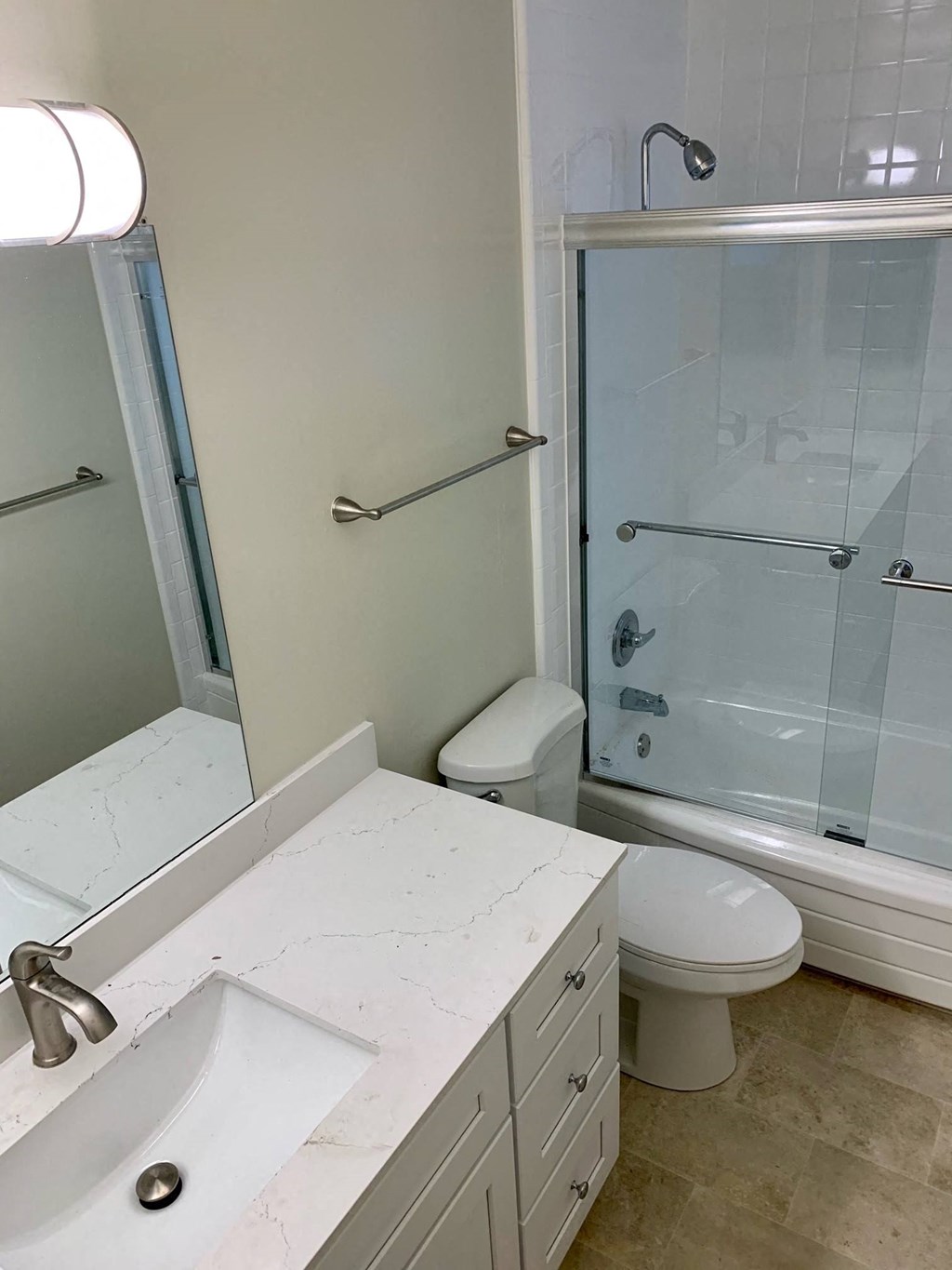 Bermuda Apts white bathroom with toilet vanity and shower