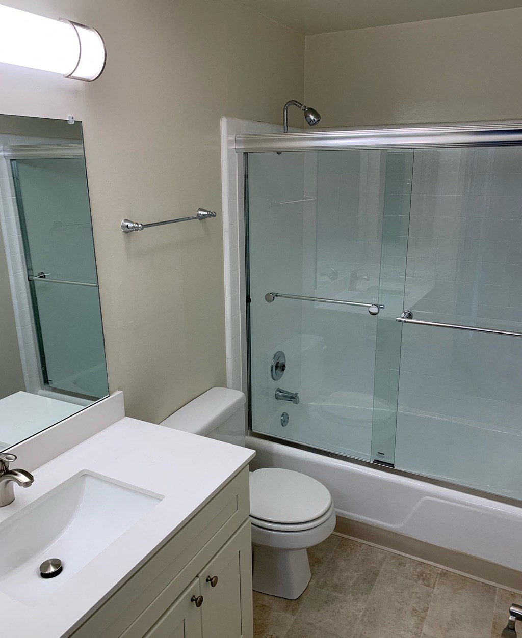 a bathroom with a shower toilet and sink