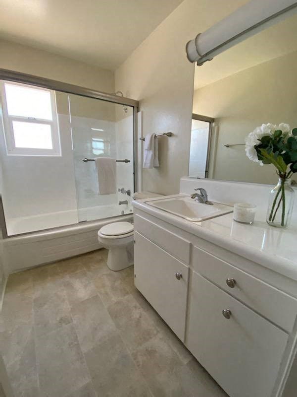 a bathroom with a sink toilet and a shower
