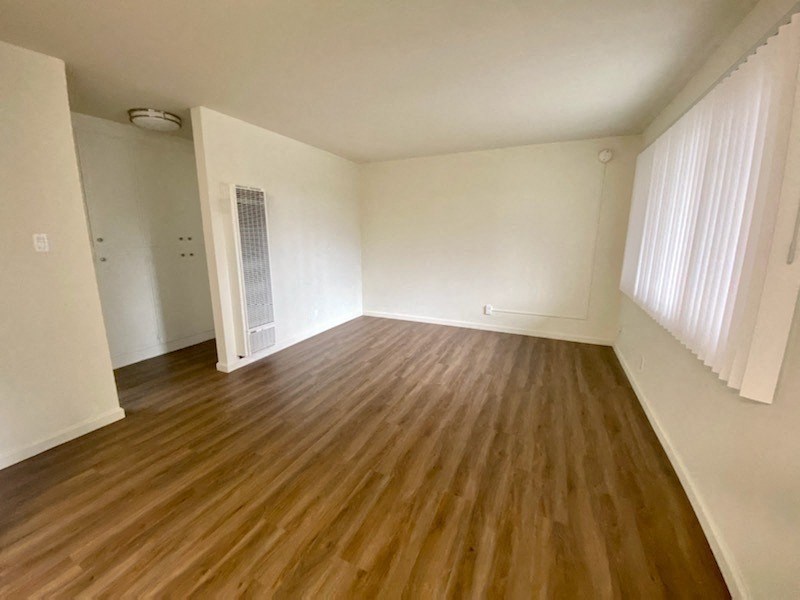 Bermuda Apts Living room with a wall heater