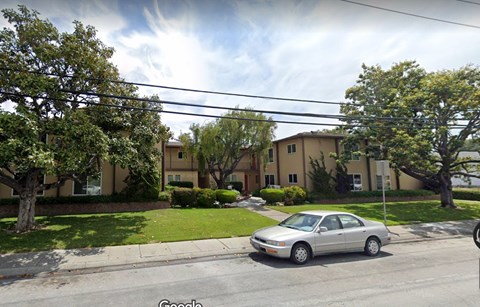 a car parked in front of an apartment building