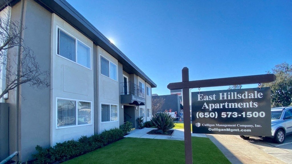East Hillsdale Apts-Side view of the building with leasing sign