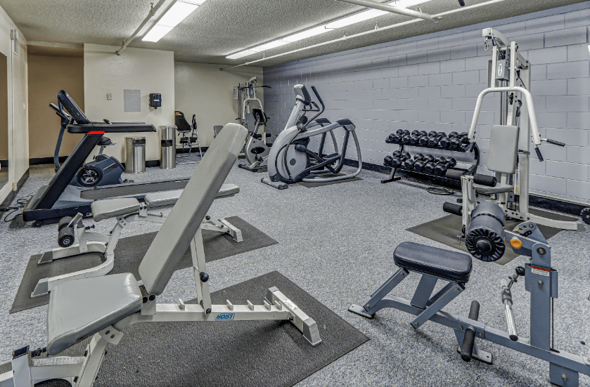 a gym with weights and other exercise equipment in a building