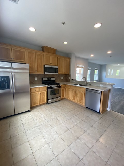 A kitchen with wooden cabinets and stainless steel appliances.