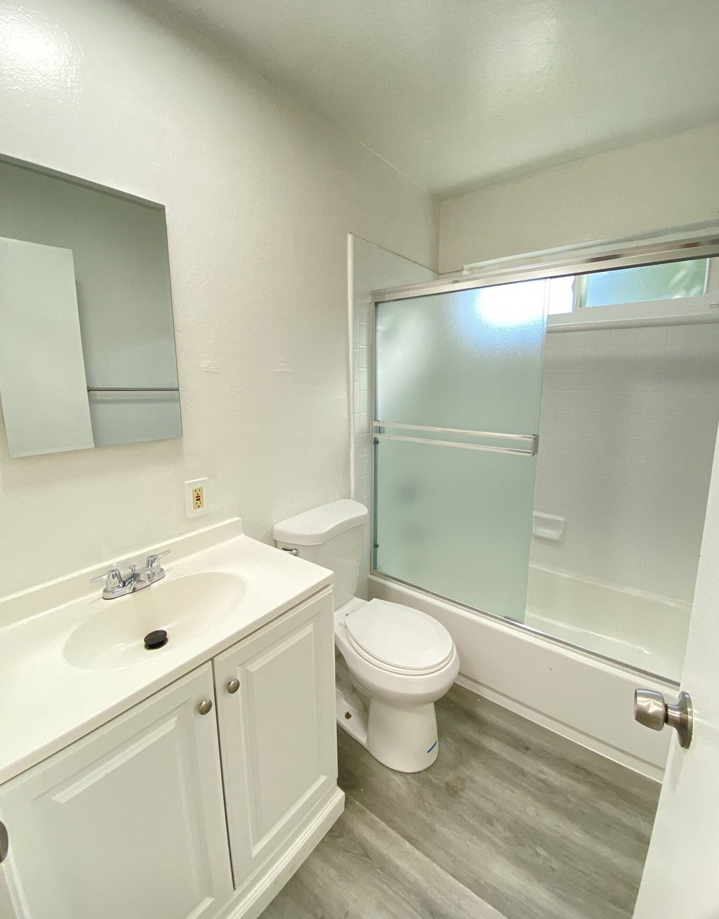 an empty bathroom with a sink toilet and shower
