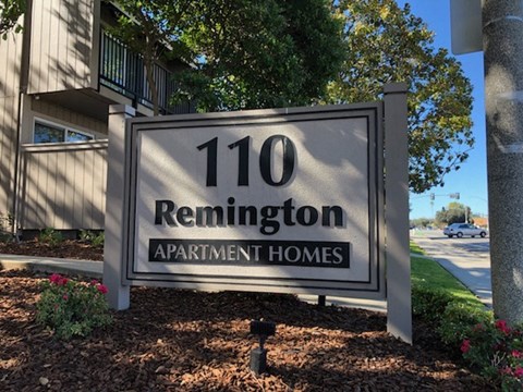 a sign in front of an apartment building