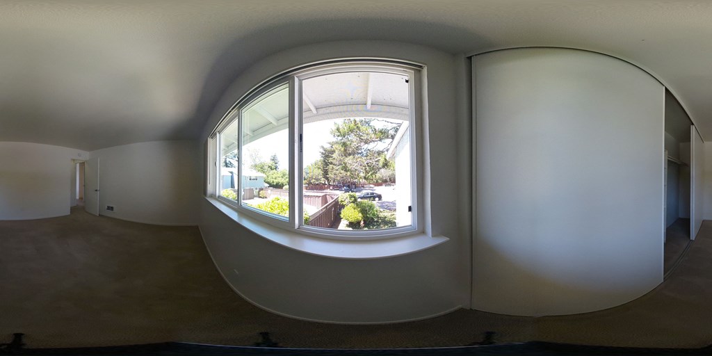 a large circular window in a room with white walls