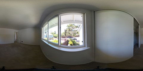 a large circular window in a room with white walls