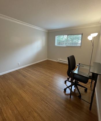 an empty room with a desk and a chair in it