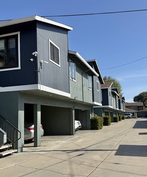 A row of houses with garages and driveways.