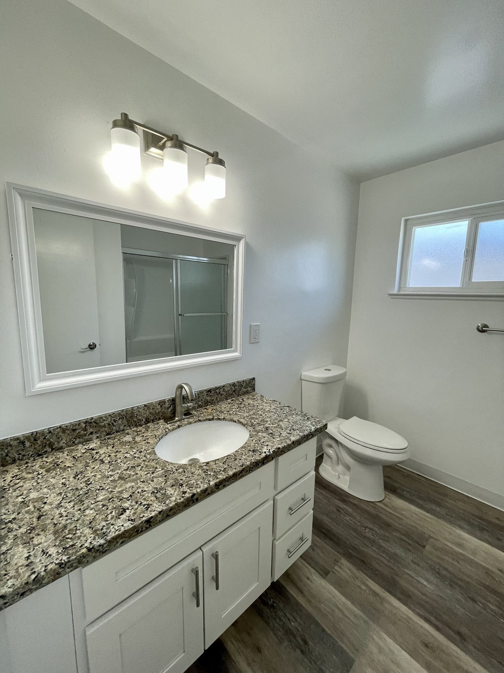 an empty bathroom with a sink and a toilet