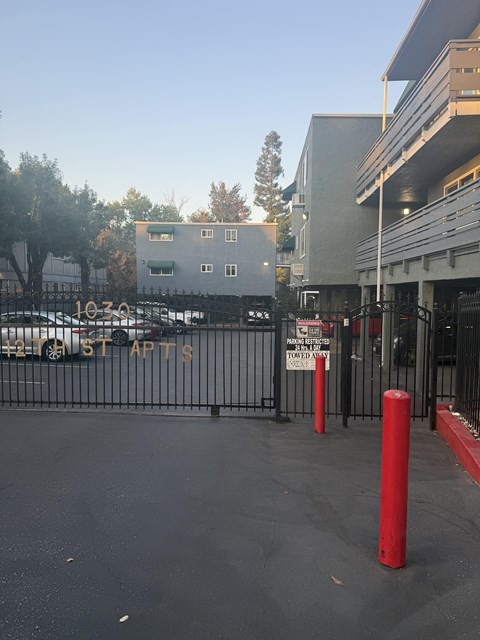 A parking lot with a sign that says "10-30" and a building in the background.