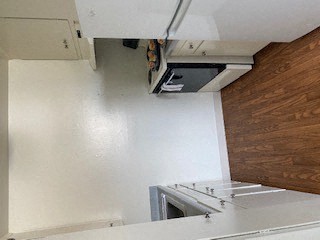 a white kitchen with a stove and a microwave