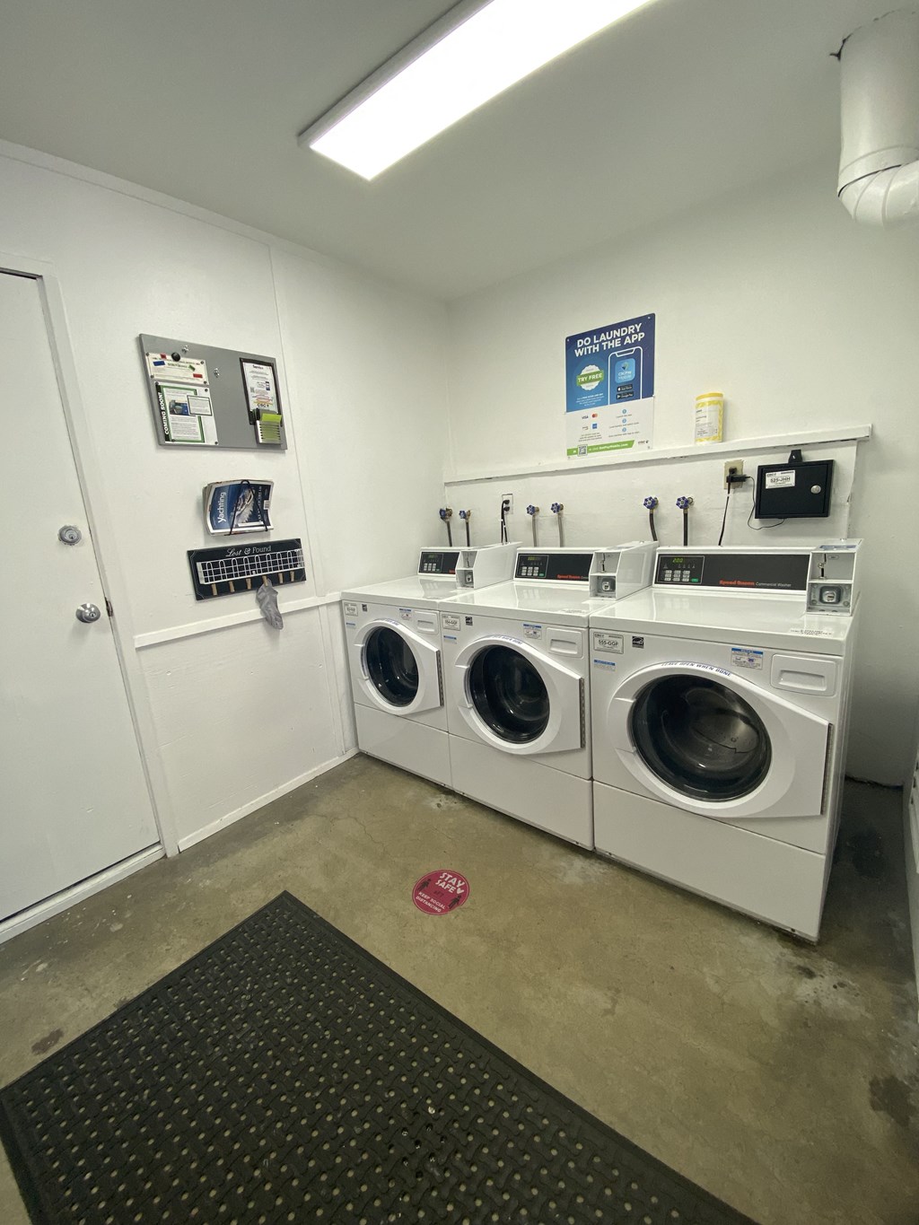 a laundry room with four washing machines in it