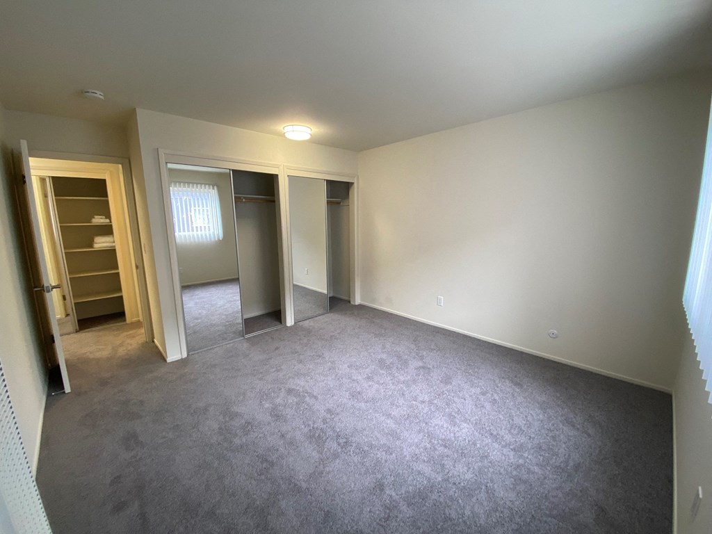 19th ave Apts- Bedroom carpeted flooring with 2 closets