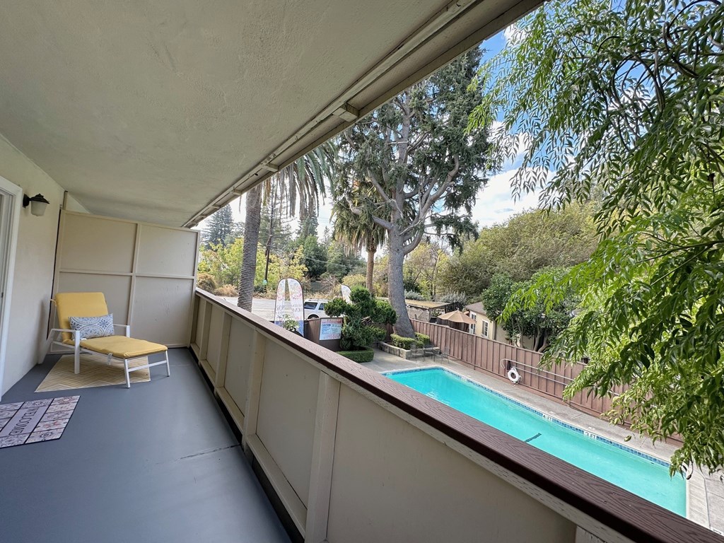 a balcony with a pool and a chair on it