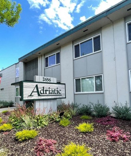 a building with a sign in front of a garden