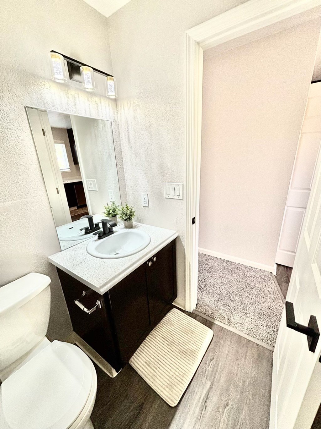 Campbell Plaza Apartments
710 Nido Drive, Campbell, CA 95008. A bathroom with a toilet, sink, and mirror.