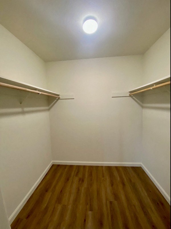 a room with two closets and wooden floors