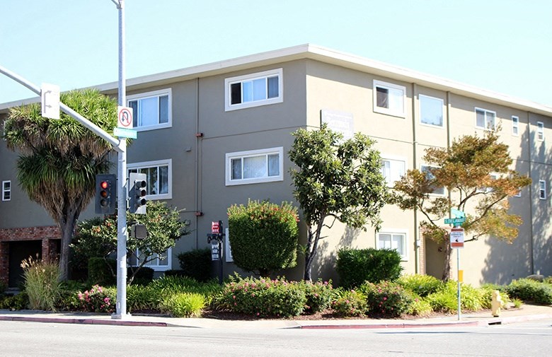 an apartment building on the corner of a street
