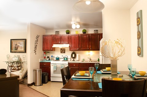 a kitchen and dining room with a table and chairs