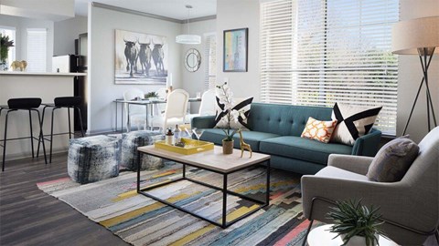 A living room with a green couch and a coffee table.