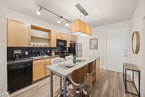 A modern kitchen with a table and chairs.