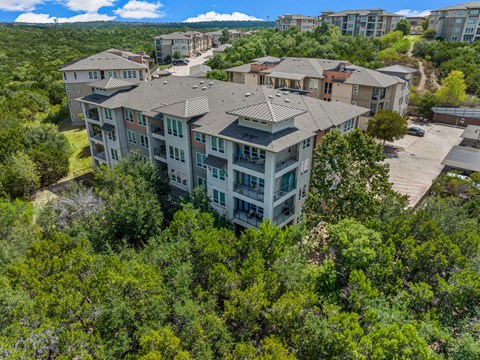A bird's eye view of apartment buildings surrounded by trees.