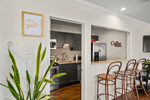 A kitchen with a framed sign that says