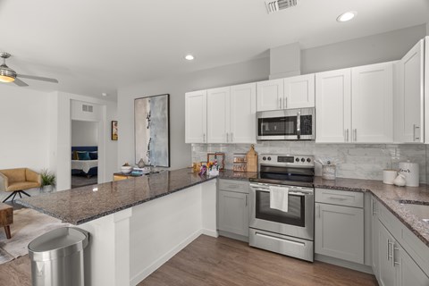 A modern kitchen with a stainless steel oven and microwave.