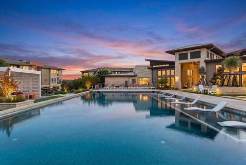 A large swimming pool in front of a modern building.