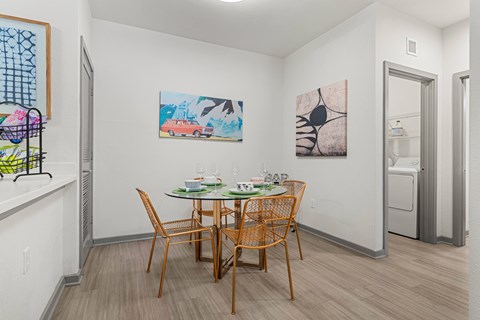 A dining room with a wooden table and chairs.