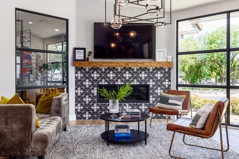 A modern living room with a fireplace and a large window.
